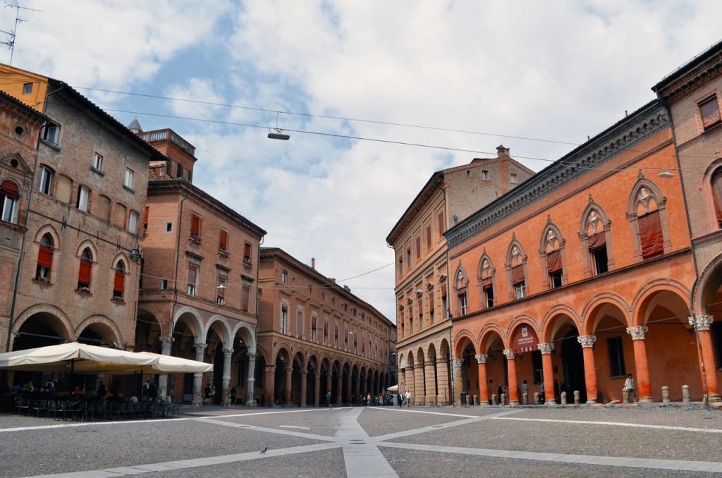 Explore the historic arcades and unique architecture in beautiful Bologna, Italy.